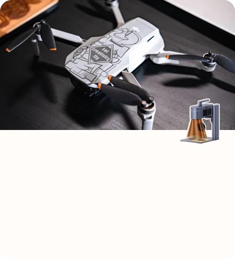 A drone customized with engraved graphic artwork placed on a desk.