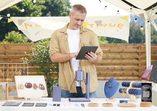 A small business owner using LaserPecker LP4 at a local craft fair for on-the-spot custom laser engraving.
