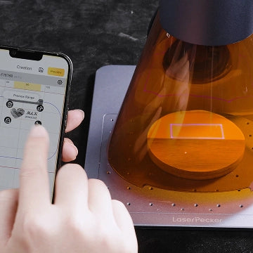 A user dragging a design on a smartphone screen for real-time preview before laser engraving.