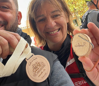 A man and a woman holding wooden awards and keepsakes engraved with a laser engraving machine.